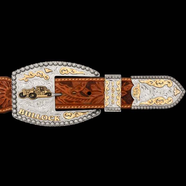 "Our Farmersville Custom 3-Piece Buckle Set is intricately hand-engraved on a German Silver base, featuring Jeweler's Bronze accents. From the western-inspired scrollwork and lettering to the custom logo tractor with hand-painted enamel, every detail